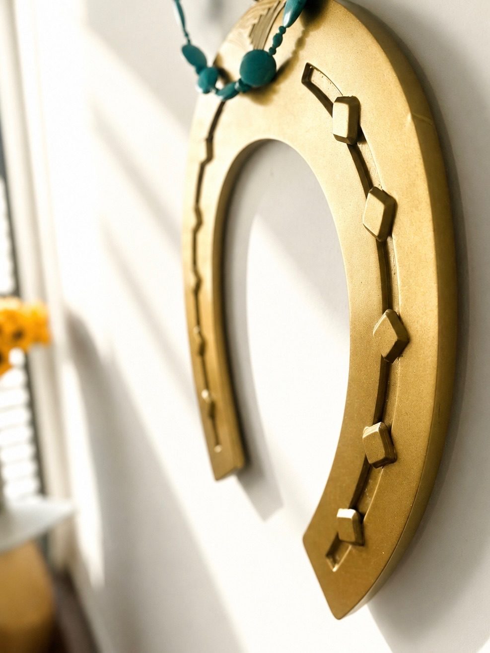 HORSESHOE WALL NECKLACE, gilded brass with turquoise beads