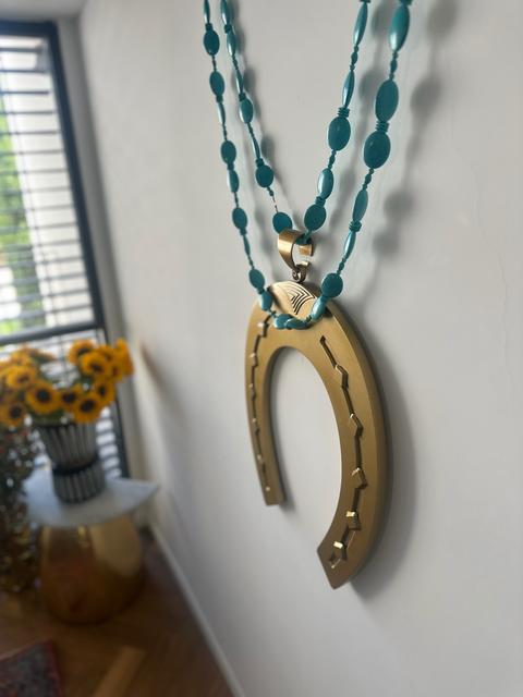 HORSESHOE wall necklace by Tali Veinrib, gilded brass on a strand of turquoise beads, view 2