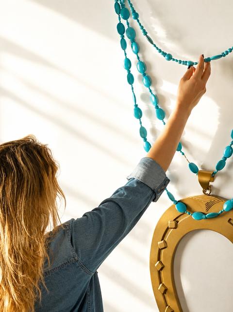 HORSESHOE wall necklace by Tali Veinrib, gilded brass on a strand of turquoise beads, view 3
