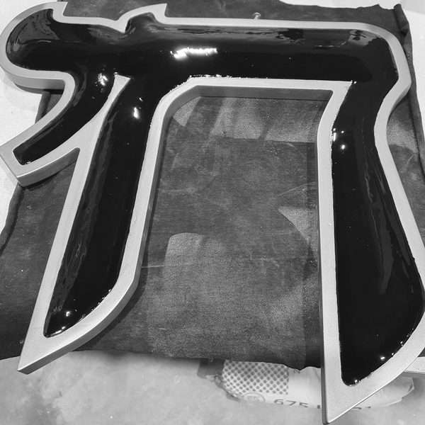 The Hai symbol on the workbench, freshly hand-filled with enamel